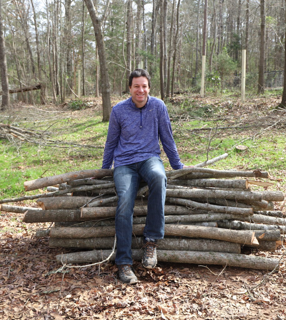 Chris atop his log pile