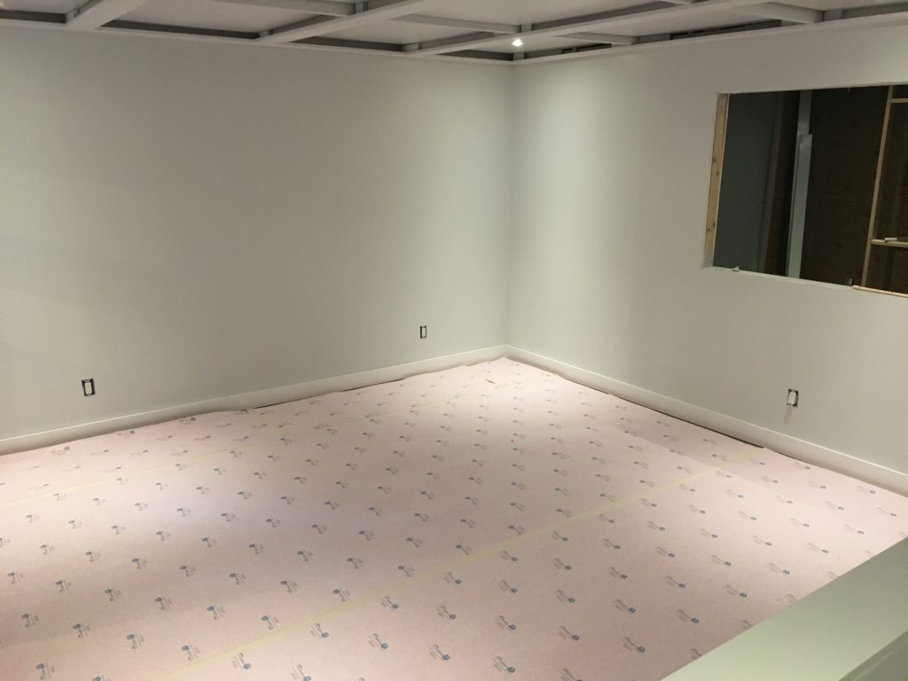 Carpet pad over DMX Airflow underlayment in basement rec room