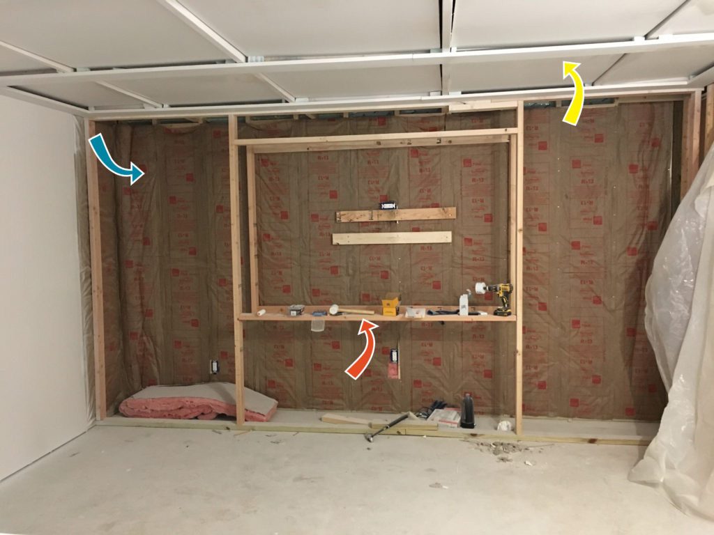 Basement media room in progress, insulation, coffered ceilings, built in wall unit.