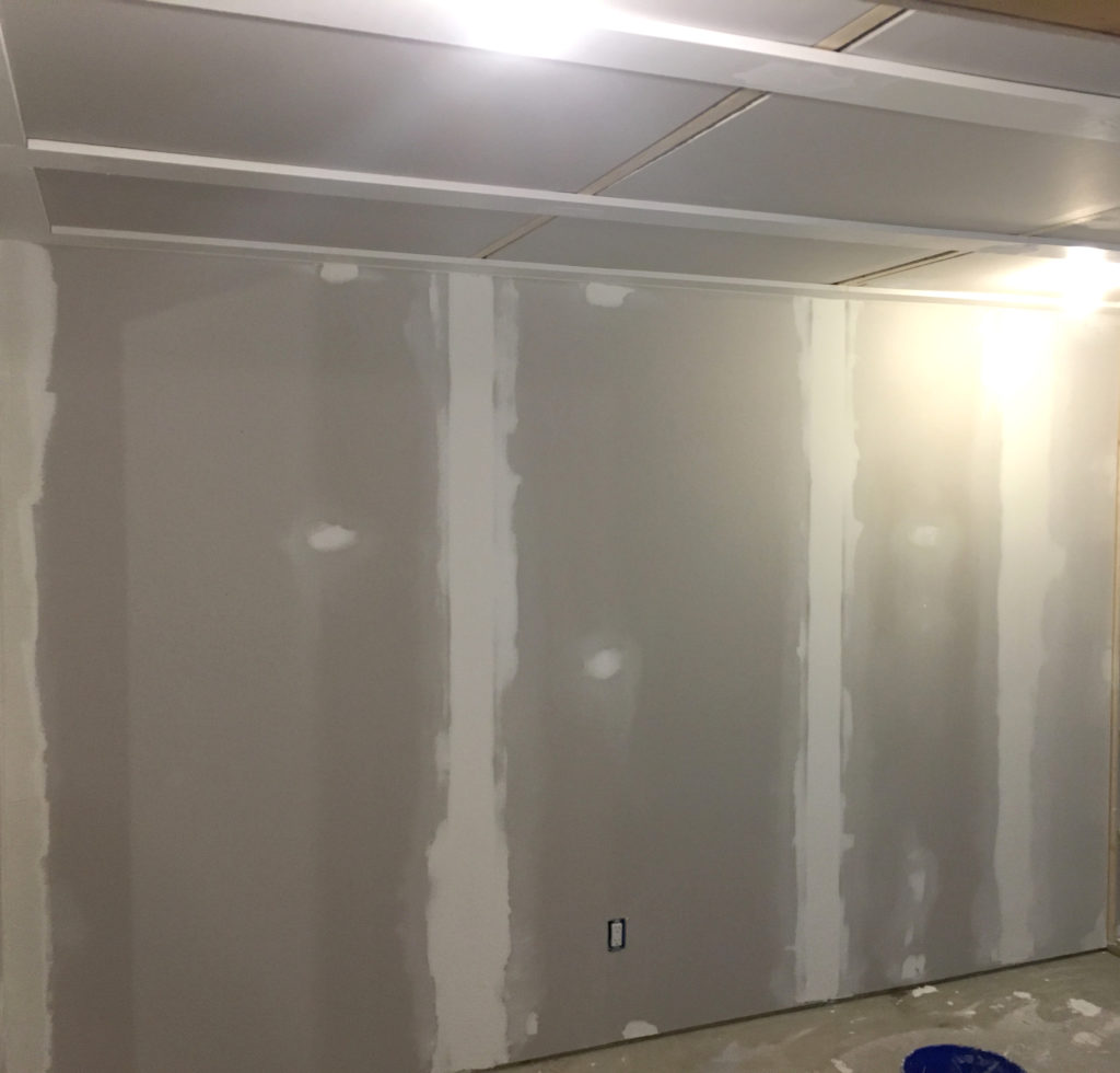 Drywall taped and mudding in basement