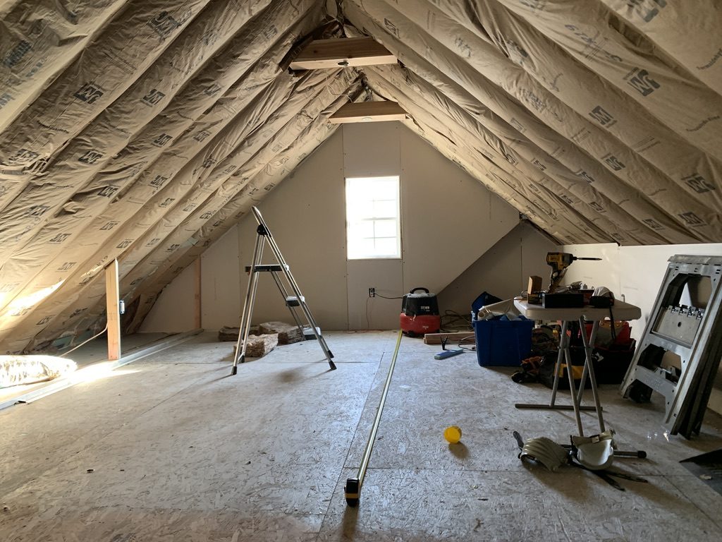 Installing insulation in the room over the garage former attic