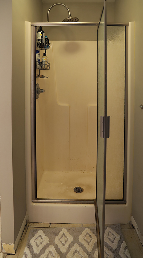 Drop in fiberglass master shower before renovation