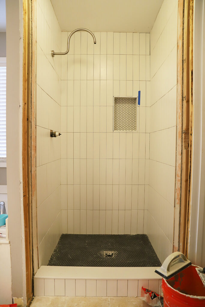 installed vertical matte subway tile with shower niche