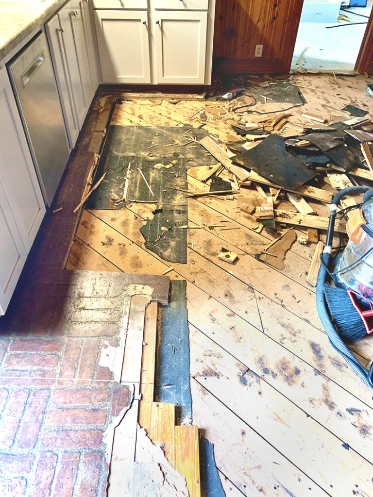 Tearing up the kitchen flooring layers down to the subfloor