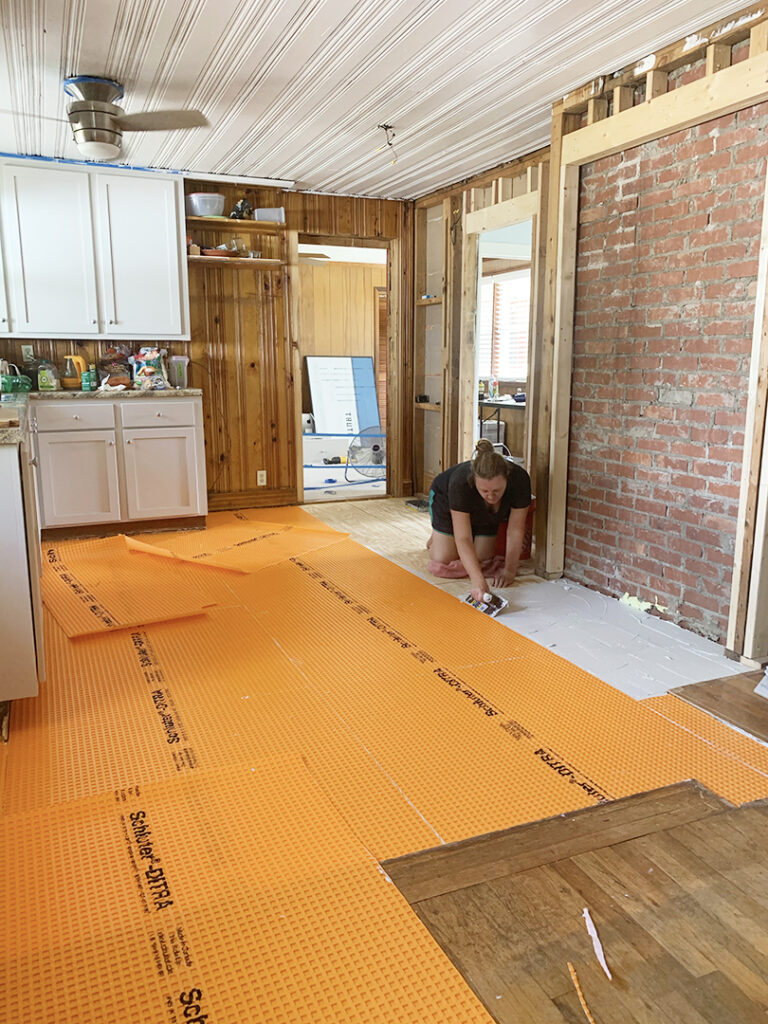 Installing Schluter Ditra waterproof uncoupling membrane on kitchen floor