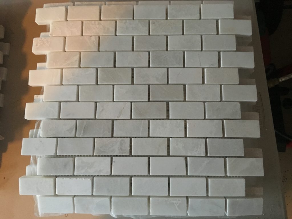 Small marble subway tile for the fireplace surround