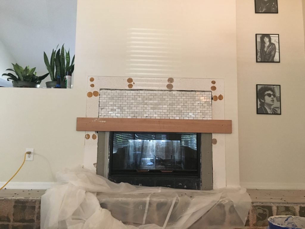 Small marble subway tile installed around the fireplace